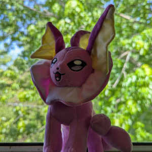 A pink Vaporeon plushie.